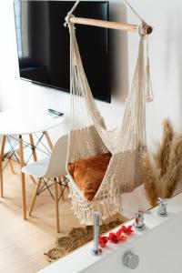 a hammock hanging from a wall in a living room at Ode à l'amour : studio intimiste in Toulon