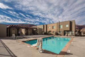 a pool at a resort with mountains in the background at Entrada at Moab 429 in Moab