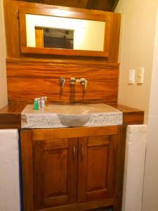 a bathroom with a sink and a mirror at Hotel Pepen in San Cristóbal de Las Casas