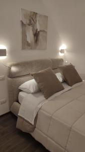 a bedroom with a large white bed with two lamps at NICOLAUS SUITE Wellness Experience in Bari Palese