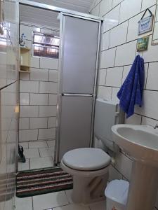 a bathroom with a shower and a toilet and a sink at Casa Amarela in Paraty