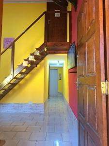 an empty hallway with a staircase in a building at Casa Amarela in Paraty