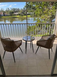 a patio with a table and chairs and a view of a lake at Great location with lake view in Naples