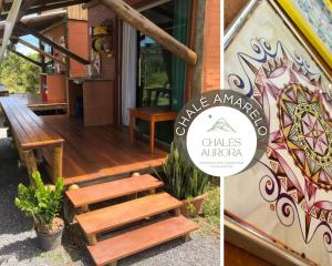 a house with a wooden staircase and a sign that reads village american chinese at Chalés Aurora in Cavalcante