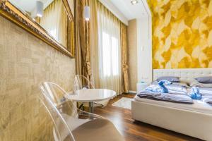 a bedroom with a bed and a table and a sink at Chain Bridge Studio Apartment in Budapest
