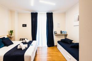 a bedroom with two beds and a window at Gegix's Rooms Milano in Milan