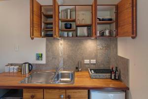 a kitchen with a sink and a counter top at Chalet Karaka in Takaka