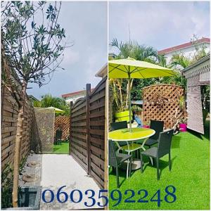 a table with a yellow umbrella in a backyard at Tartane beach spa in La Trinité