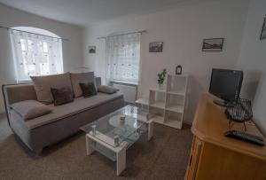 a living room with a couch and a tv at Apartmá u Baštů in Česká Kamenice