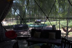 a living room with a couch in a tent at RetroDOMOS in Coinco