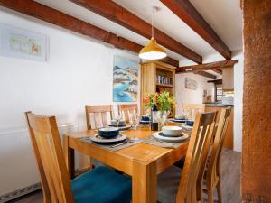 a dining room with a wooden table and chairs at Pond Meadow in Launceston