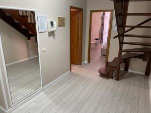 a hallway with a mirror and stairs in a house at SUN TOWER-CENTER of TIRANA in Tirana