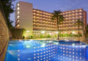 a hotel with a swimming pool in front of a building at Eurosalou & Spa in Salou