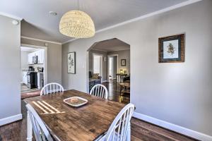 a dining room with a wooden table and white chairs at Birmingham Home Walk to Ruffner Mountain! in Birmingham