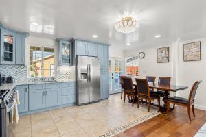 a kitchen with a dining table and a refrigerator at Goleta Getaway in Santa Barbara