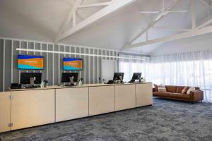 a lobby with a reception desk with two computers on it at BIG4 West Beach Parks in Adelaide