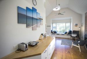 a kitchen and living room with a table and chairs at GALWAY COTTAGE in Queenscliff