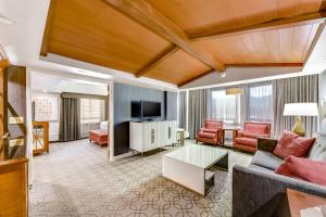 a living room with a couch and a tv at Harrah's Lake Tahoe Hotel & Casino in Stateline