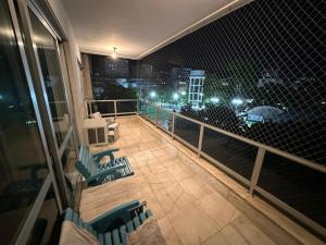 a balcony with a view of a city at night at Quarto Aconchegante in Rio de Janeiro