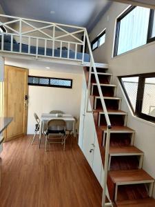 a loft bed in a tiny house at Tiny house with extended camping area for large groups in Puerto Viejo