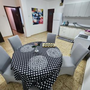 a table with a black and white table cloth on it at SEA VIEW ASHDOD in Ashdod