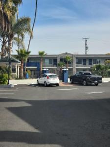 two cars parked in a parking lot in front of a building at Studio 6 Vallejo CA Napa Valley in Vallejo