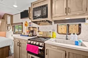 an rv kitchen with a sink and a stove at Park access! Bars & Restaurants close-by! Private in Austin