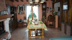a dining room with a table and a fireplace at Chambres d'Hôtes de Boudeville in Boudeville