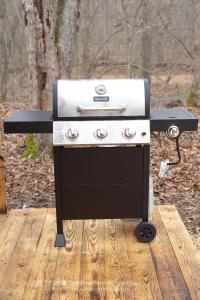 a black and white grill sitting on a wooden deck at Creekside Glamping Current River Mark Twain Forest in Doniphan