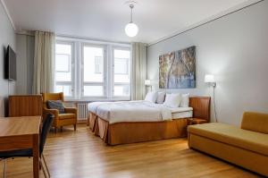 a hotel room with a bed and a table and chairs at Radisson Blu Aleksanteri Hotel, Helsinki in Helsinki