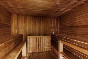 an empty wooden sauna with wooden floors and walls at Radisson Blu Aleksanteri Hotel, Helsinki in Helsinki