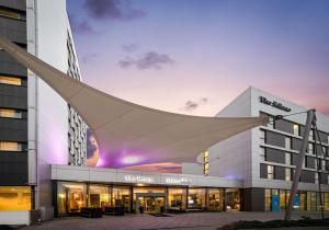 a rendering of a hospital building at dusk at The Rilano Hotel München in Munich