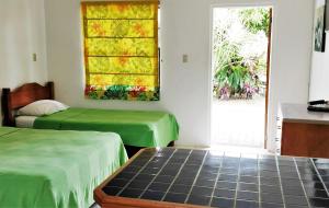 Llit o llits en una habitació de Bananaquit Near the beach!
