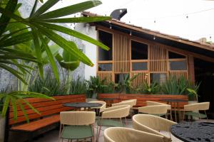 a patio with tables and chairs in front of a building at Hotel Pajara Pinta in Cali