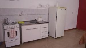 a kitchen with a white refrigerator and a sink at Mi Lugar in Olavarría