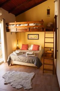 a bedroom with two bunk beds and a ladder at Posada La Serena in Minas