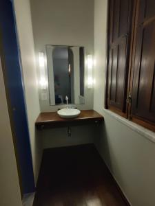 a bathroom with a sink and a mirror at Hotel Villa Salvador in Salvador