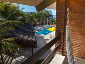 a view of a swimming pool from the balcony of a house at Pousada Ponta do Lobo in Balneário Camboriú
