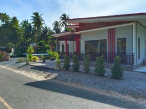a house with a flag on the side of it at ST Mansion in Khanom