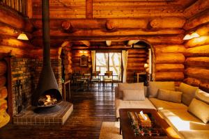 a living room with a fireplace in a log cabin at RENEST in Kobe