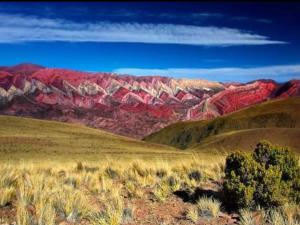 a view of a mountain range with red rocks at Hostal familiar Hornocal in Humahuaca