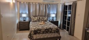 a bedroom with a bed with a stuffed animal on it at Komfort Getaway Villa in Ocho Rios