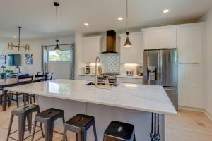 a kitchen with a large island with bar stools at Luxury Downtown Nash/Roofdeck/11 Beds in Nashville