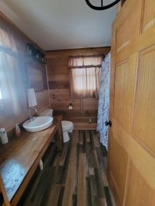 a bathroom with a sink and a toilet and a door at Mallory Estate in Chariton