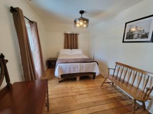 a bedroom with a bed and a wooden floor at Mallory Estate in Chariton