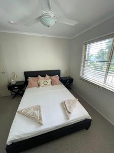 a bedroom with a large bed with two pillows on it at Whitsundays Bayview Escape in Cannon Valley