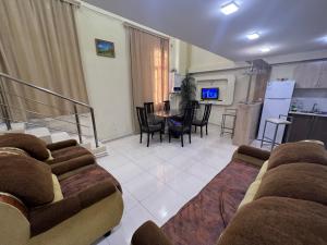 a living room with a couch and a table at Dublex Apartment in Yerevan komitas 3 bedrooms D2 in Yerevan