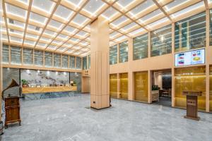 a lobby of a building with a large ceiling at Guangzhou Boyi Hotel in Guangzhou