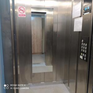 an elevator with a mirror in a building at Apartment in Yerevan komitas K1 in Yerevan