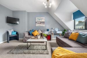 a living room with a couch and a table at Great North Getaways - Newcastle upon Tyne in Jesmond